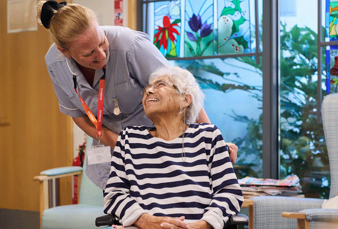 St Helena Hospice staff member providing support to a patient